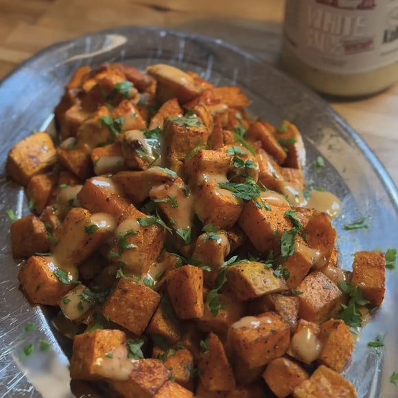 Thumbnail for article: Whomp-Rubbed Sweet Potatoes with White Sauce Drizzle