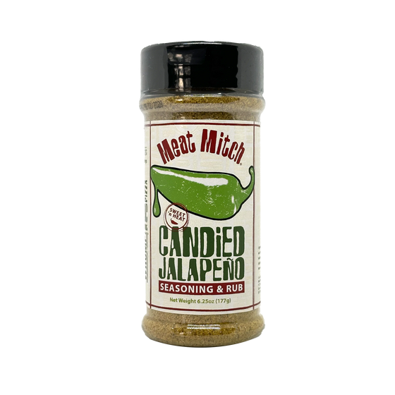 A clear plastic spice shaker with a black lid and a beige label wrapped around its middle. The label features a green jalapeno pepper illustration and the text "Meat Mitch" in a stylized font at the top. Below the jalapeno image, it reads "SWEET N HEAT" in small letters. The main text on the label is "CANDIED JALAPENO", followed by "SEASONING & RUB" in smaller letters. The net weight of the seasoning is listed as 6.25oz (177g). The shaker is filled with a light brown seasoning blend.